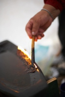 Photo of hot fire and a callused hand